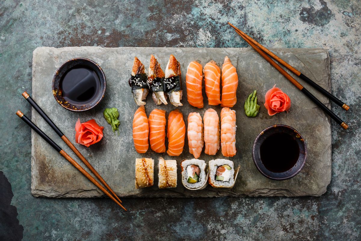 a slate board with sushi on it