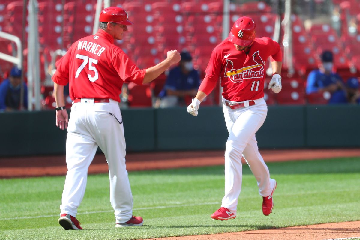 Paul DeJong #11 of the St. Louis Cardinals celebrates with base coach Ron Warner #75 of the St. Louis Cardinals after hitting a two-run home run against the Kansas City Royals at Busch Stadium on July 22, 2020 in St Louis, Missouri.