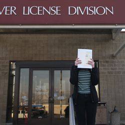 Samantha Leef, 16, hides behind her new learner's permit as her mother tries to take her photograph at the Driver License Division in West Valley City on Wednesday, Jan. 30, 2019.