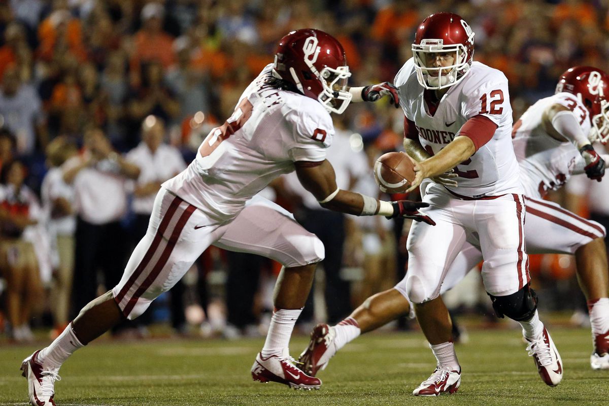 September 1, 2012; Dallas, TX, USA; Oklahoma Sooners quarterback Landry Jones (12) hands off to running back Dominique Whaley (8) in the second quarter against the UTEP Miners at Sun Bowl Stadium. Mandatory Credit: Jim Cowsert-US PRESSWIRE