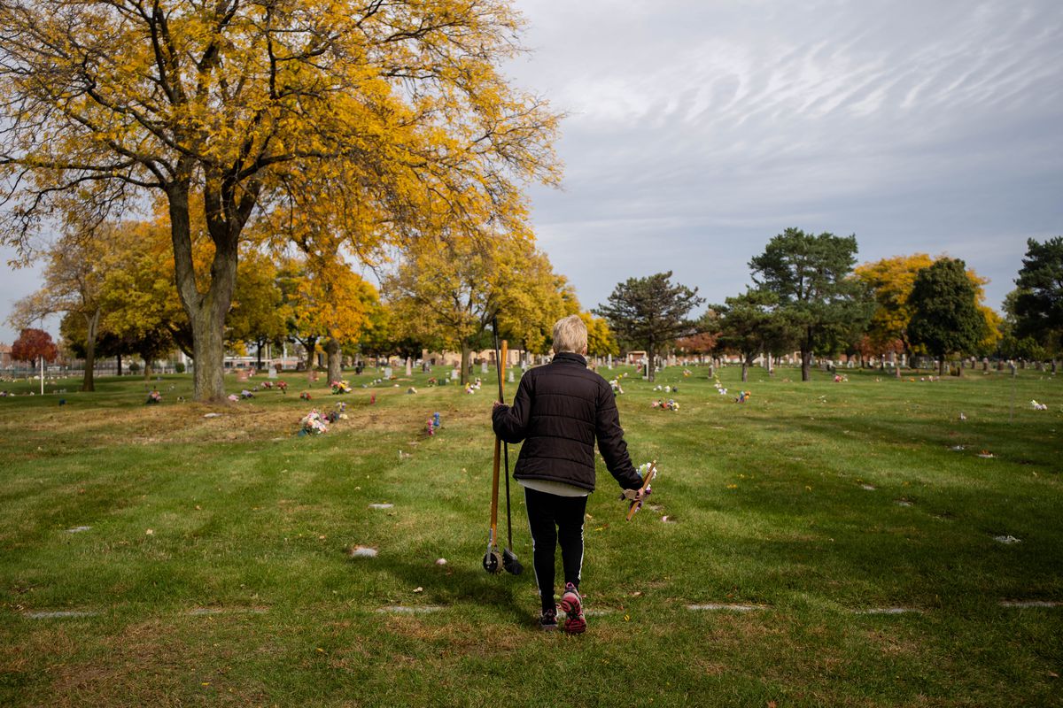 Sandra Bartusiak, 79, of Plainfield, walks to tend her parents’ graves at St. Mary Catholic Cemetery in Evergreen Park.