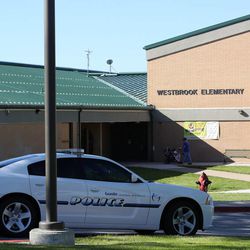 A police car is parked in front of Westbrook Elementary School in Taylorsville on Thursday, Sept. 11, 2014. A teacher accidentally shot herself in the leg, while alone in a faculty bathroom, shortly before school started.