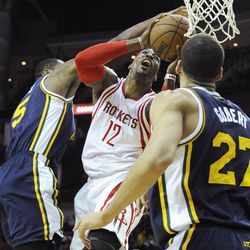 Houston Rockets' Dwight Howard is blocked by Utah Jazz's Rodney Hood (5) as Rudy Gobert (27) looks on in the first half of an NBA basketball game Wednesday, March 23, 2016, in Houston. (AP Photo/Pat Sullivan)