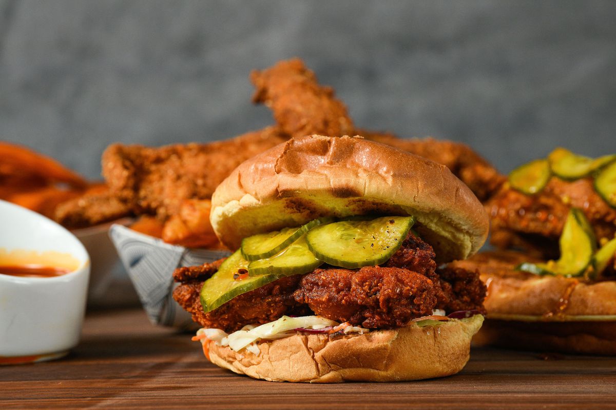A fried chicken sandwich with pickles.
