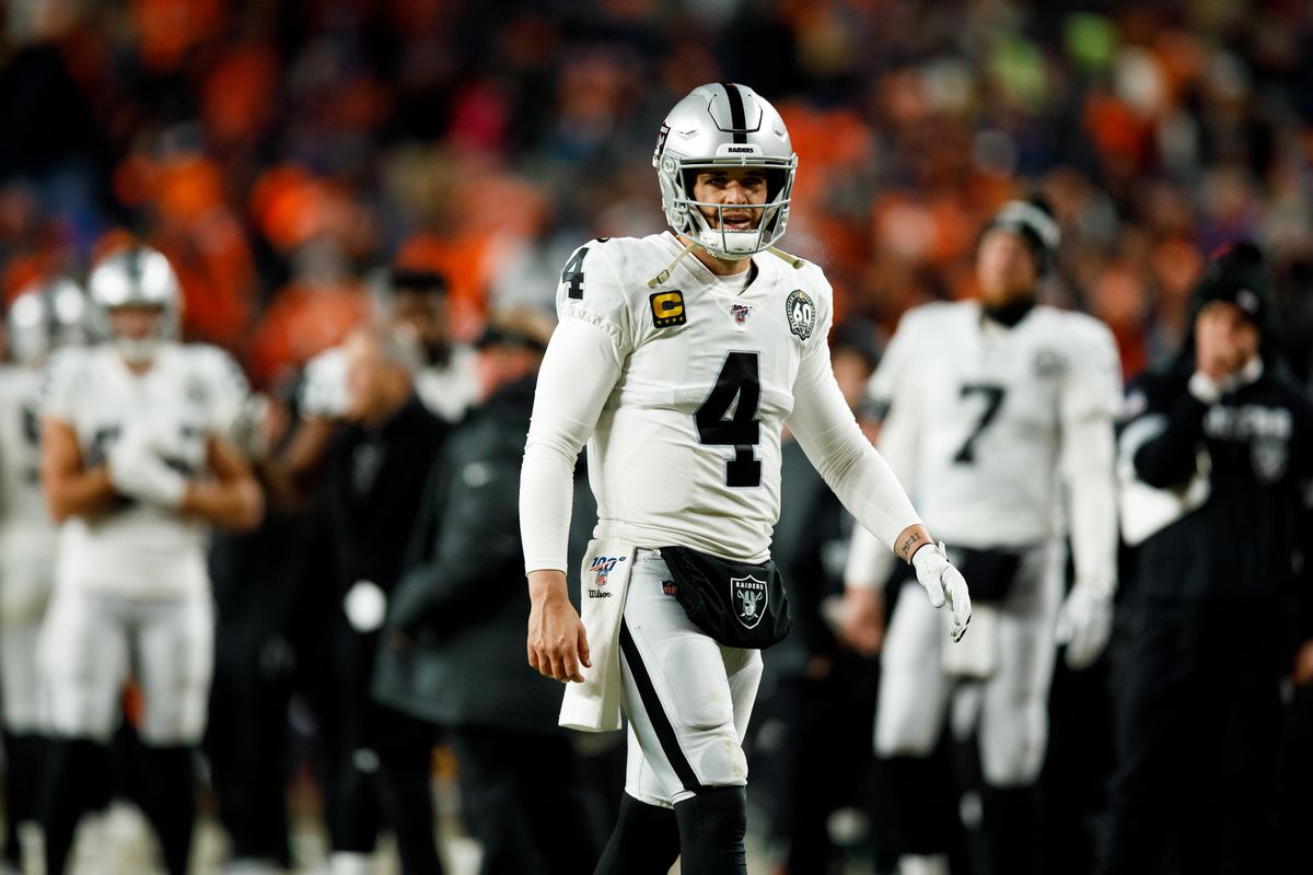 Quarterback Derek Carr of the Oakland Raiders walks on the field against the Denver Broncos during the fourth quarter at Empower Field at Mile High on December 29, 2019 in Denver, Colorado. The Broncos defeated the Raiders 16-15.