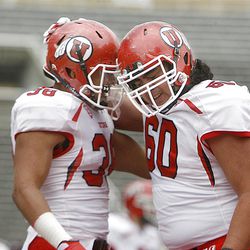 Karl Williams (left) and Siaosi Aiono celebrate during the Red-White game at Rice-Eccles Stadium at the University of Utah in Salt Lake City on Saturday, April 20, 2013.