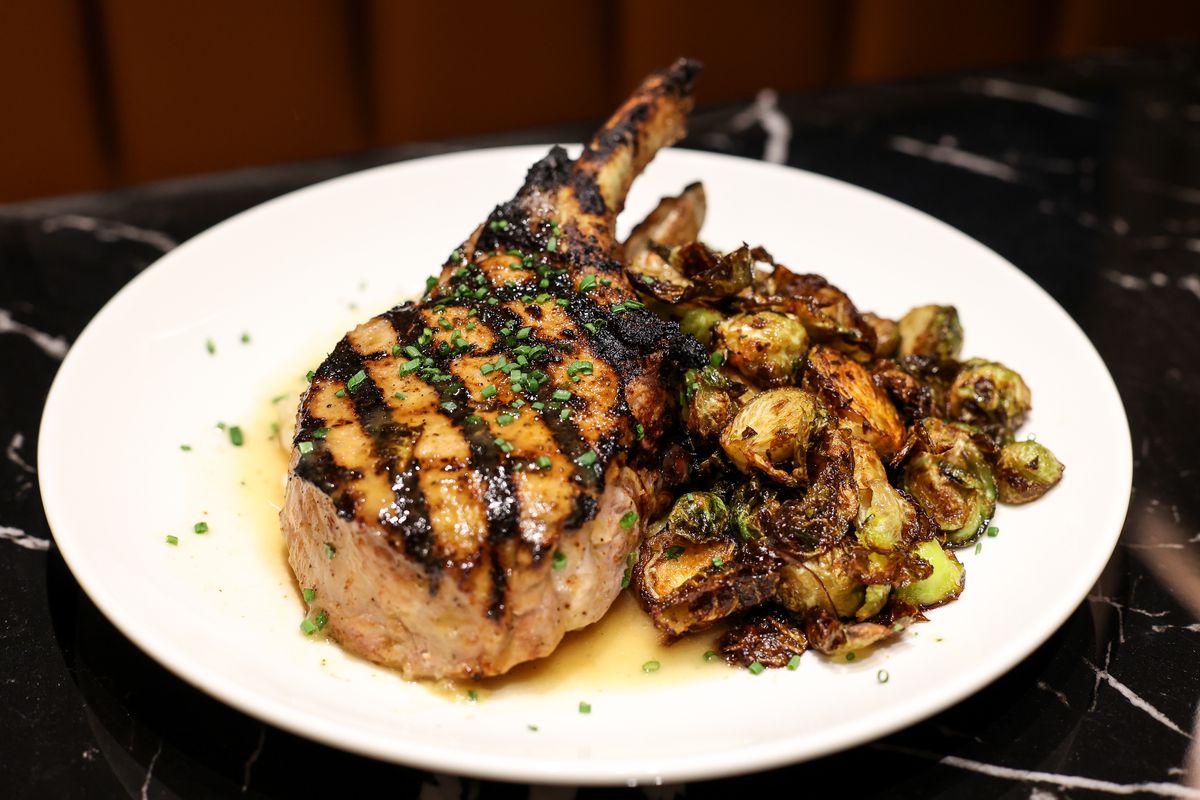 The Warwick’s grilled porkchop, served with a side of roasted Brussel sprouts.
