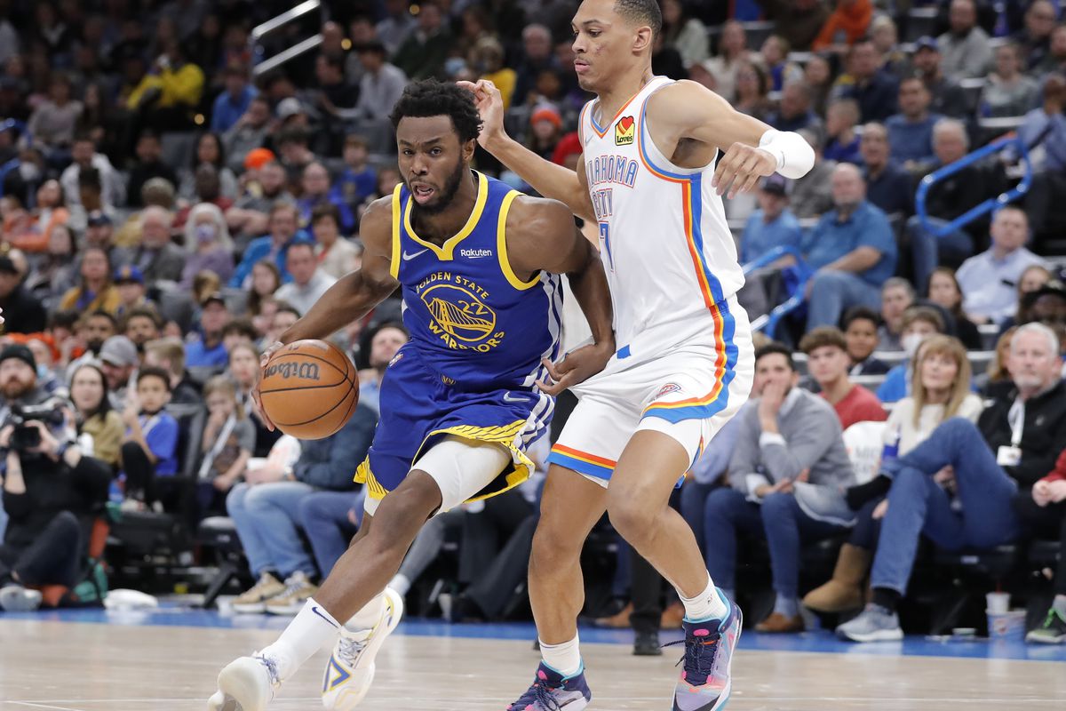 Golden State Warriors forward Andrew Wiggins (22) drives to the basket around Oklahoma City Thunder forward Darius Bazley (7) during the second quarter at Paycom Center. 