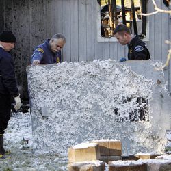 Officials investigate at the home of Josh Powell in Graham, Wash., Monday, Feb. 6, 2012.