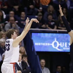 Gonzaga's Kyle Wiltjer, left, shoots against BYU's Nate Austin during the first half of an NCAA college basketball game, Thursday, Jan. 14, 2016, in Spokane, Wash. (AP Photo/Young Kwak)
