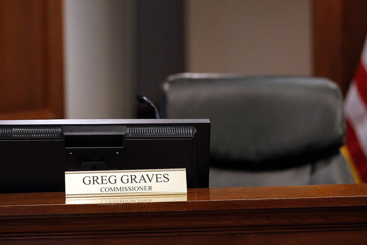 FILE - Utah County Commissioner Greg Graves' chair is empty as he participates by phone during commission meeting in Provo on Tuesday, Dec. 12, 2017.