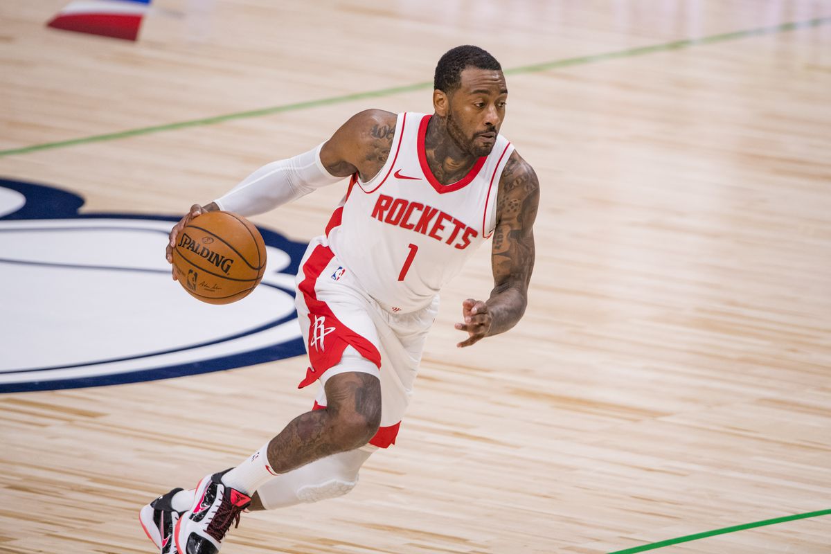 Houston Rockets guard John Wall (1) brings the ball up court against the Dallas Mavericks during the second half at the American Airlines Center.