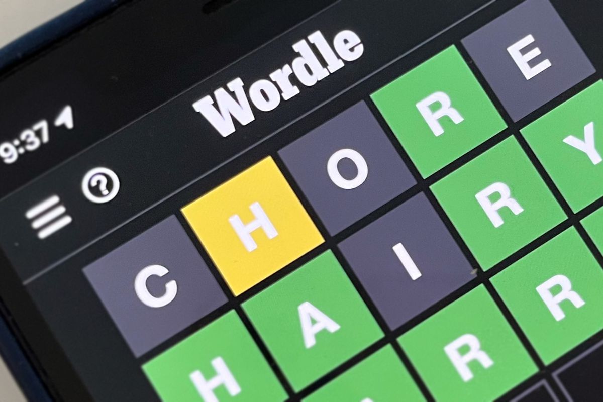 A photo of an iPhone displaying a Wordle puzzle solution from the past, “HARRY”