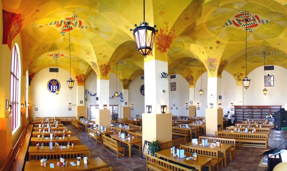 A German-inspired dining room with yellow walls and high ceilings.