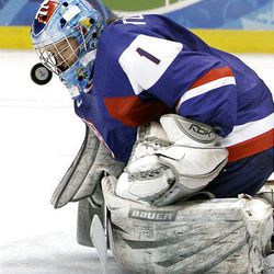 Slovakia goalie Zuzana Tomcikova is hit in her mask with the puck during a preliminary round women's ice hockey game against Canada at the 2010 Olympics in Vancouver, British Columbia, on Saturday.
