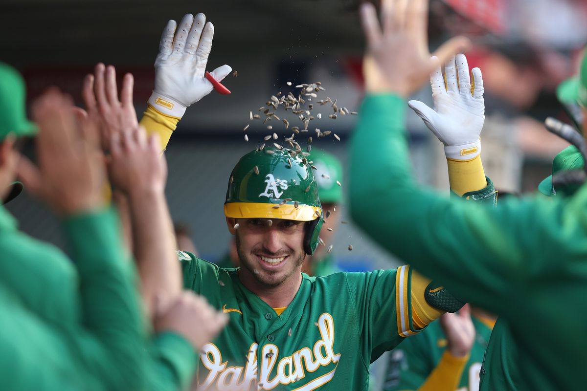 Brent Rooker of the Oakland Athletics celebrates with teammates after hitting a solo home run during the third inning against the Los Angeles Angels at Angel Stadium of Anaheim on April 24, 2023 in Anaheim, California.