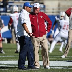 Brigham Young Cougars head coach Kalani Sitake and UMass Minutemen head coach Mark Whipple chat before a game at LaVell Edwards Stadium in Provo on Saturday, Nov. 19, 2016.