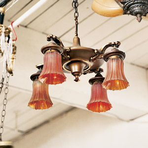 <p>This four-arm brass fixture with scarlet shades shaped like tulips dates to the 1920s.</p>