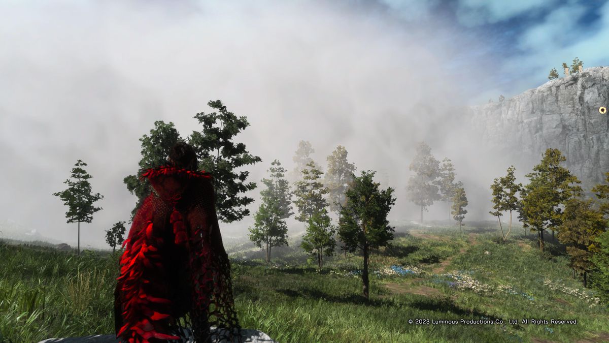 Frey Holland stands in front of some clouds in a field peppered by trees on an otherwise bluebird day in the underrated PS5 action game Forspoken.