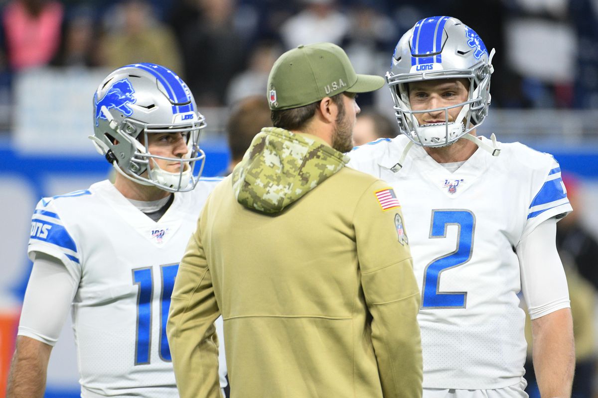 Detroit Lions quarterback Matthew Stafford talks to quarterback Jeff Driskel and quarterback David Blough before the game against the Dallas Cowboys at Ford Field.