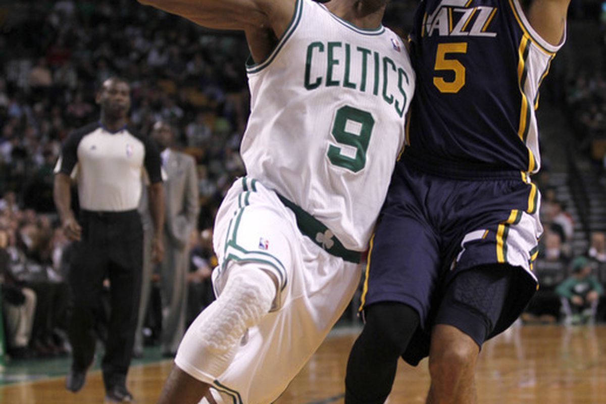 March 28, 2012; Boston, MA, USA; Boston Celtics point guard Rajon Rondo (9) drives against Utah Jazz point guard Devin Harris (5) during the third quarter at TD Banknorth Garden.   Mandatory Credit: Greg M. Cooper-US PRESSWIRE