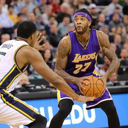 Utah Jazz forward Derrick Favors (15) defends Los Angeles Lakers center Jordan Hill (27) as the Jazz and the Lakers play Wednesday, Feb. 25, 2015, at EnergySolutions Arena in Salt Lake City.