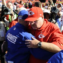 New York Giants head coach Tom Coughlin (left) talks to Kansas City Chiefs head coach Andy Reid (right) after the game at Arrowhead Stadium. Kansas City won the game 31-7.