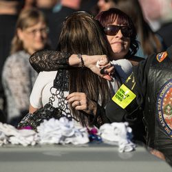 Jenny Brotherson, mother of West Valley police officer Cody Brotherson, hugs a well-wisher during her son's graveside service at Valley View Memorial Park in West Valley City on Monday, Nov. 14, 2016.