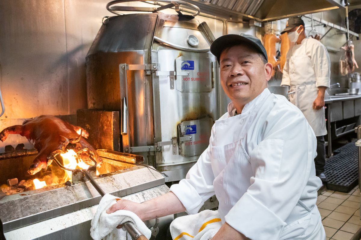 Koi Palace barbecue chef Yao Xuan Yu cooks a pig over a fire.