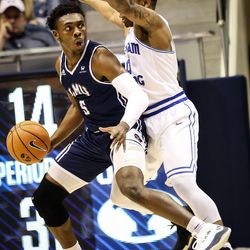 Brigham Young Cougars guard Jahshire Hardnett (0) swarms Loyola Marymount Lions guard James Batemon (5) in the second half as the Brigham Young Cougars take on the Loyola Marymount Lions at the Marriott Center in Provo on Thursday, Jan. 18, 2018.