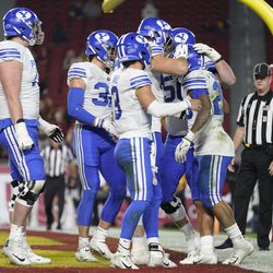 Brigham Young celebrates after running back Tyler Allgeier, right, scored a touchdown during the first half of an NCAA college football game against Southern California in Los Angeles, Saturday, Nov. 27, 2021. 
