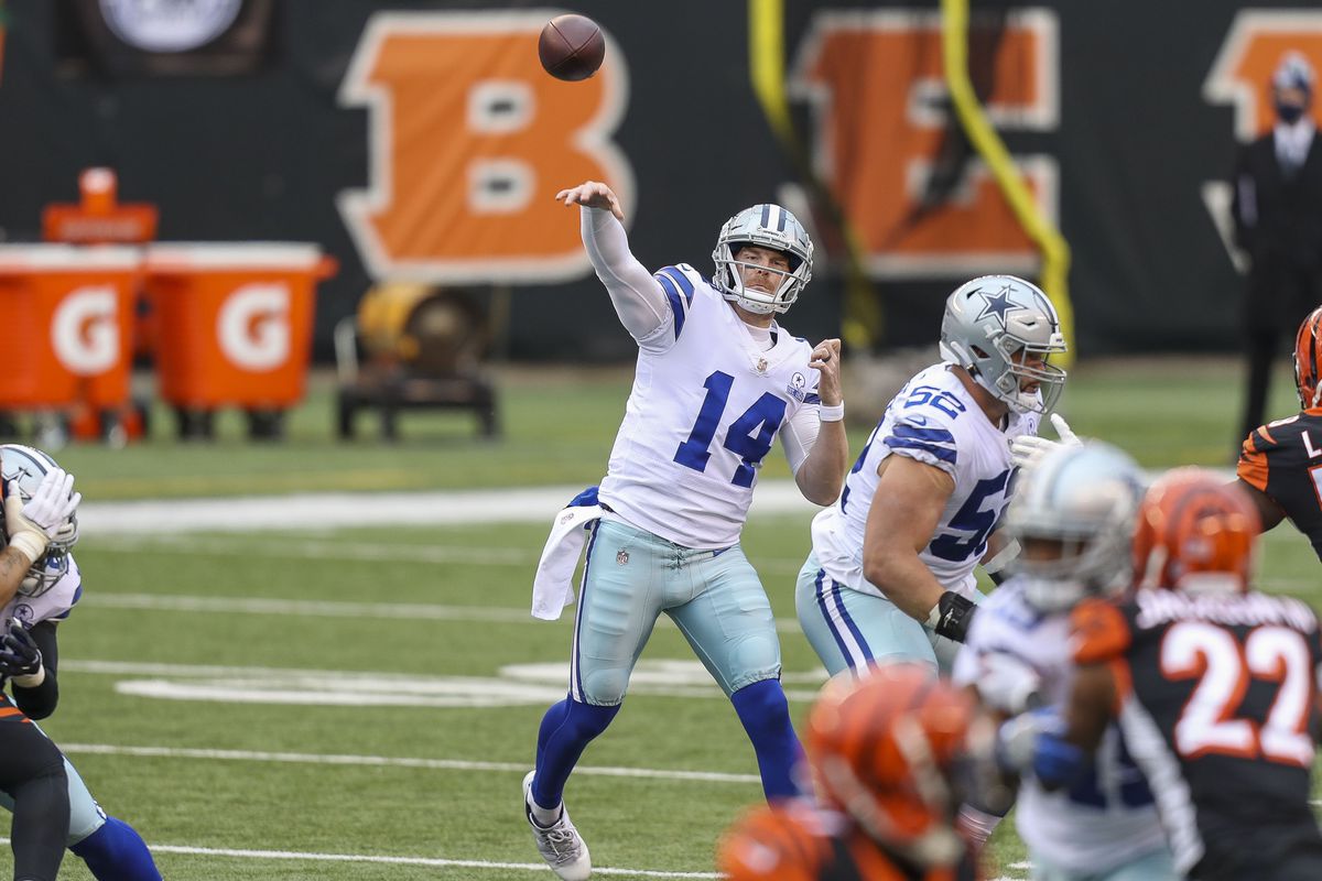 Dallas Cowboys quarterback Andy Dalton (14) throws a pass against the Cincinnati Bengals in the first half at Paul Brown Stadium.