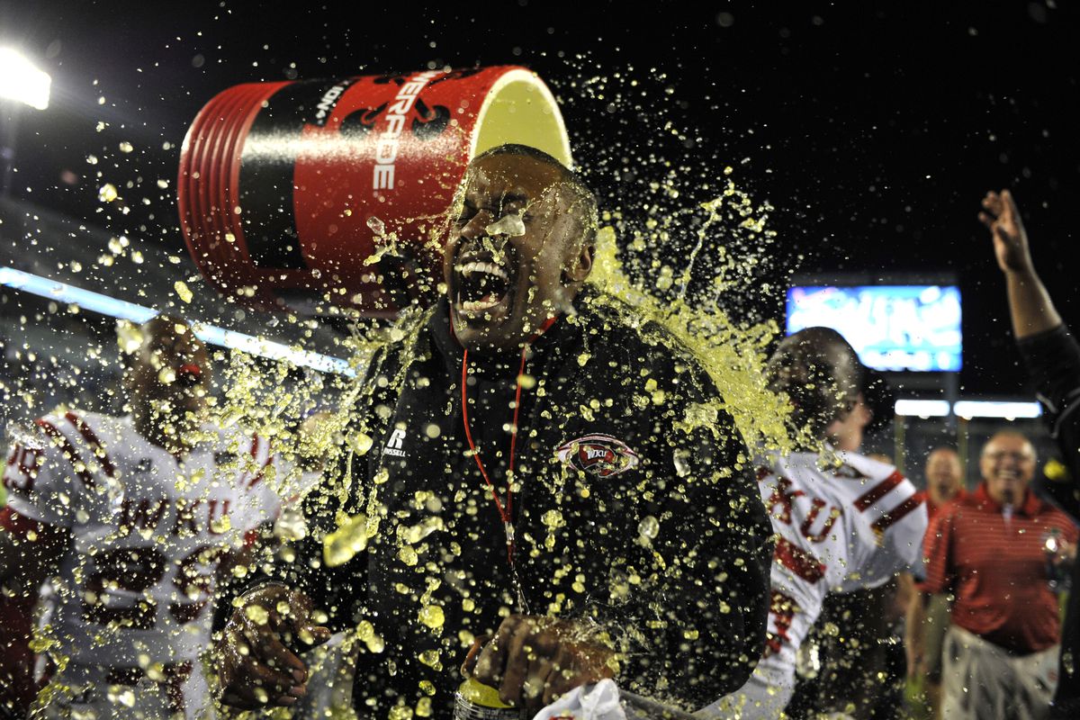 WKU head coach Willie Taggart was doused with the Powerade bucket after WKU’s win over Kentucky.  WKU won over UK in overtime 32-31 at Commonwealth Stadium on Sep. 15, 2012. 