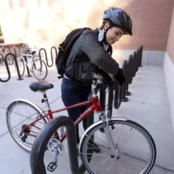 Deseret News reporter Erica Evans locks her bike after commuting from South Salt Lake to the Deseret News in Salt Lake City on Wednesday, Nov. 7, 2018.