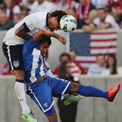 Jermaine Jones (13) of the U.S. heads the ball away from Honduras' Roger Rojas (21) as the United States and Honduras play Tuesday, June 18, 2013 at Rio Tinto Stadium.