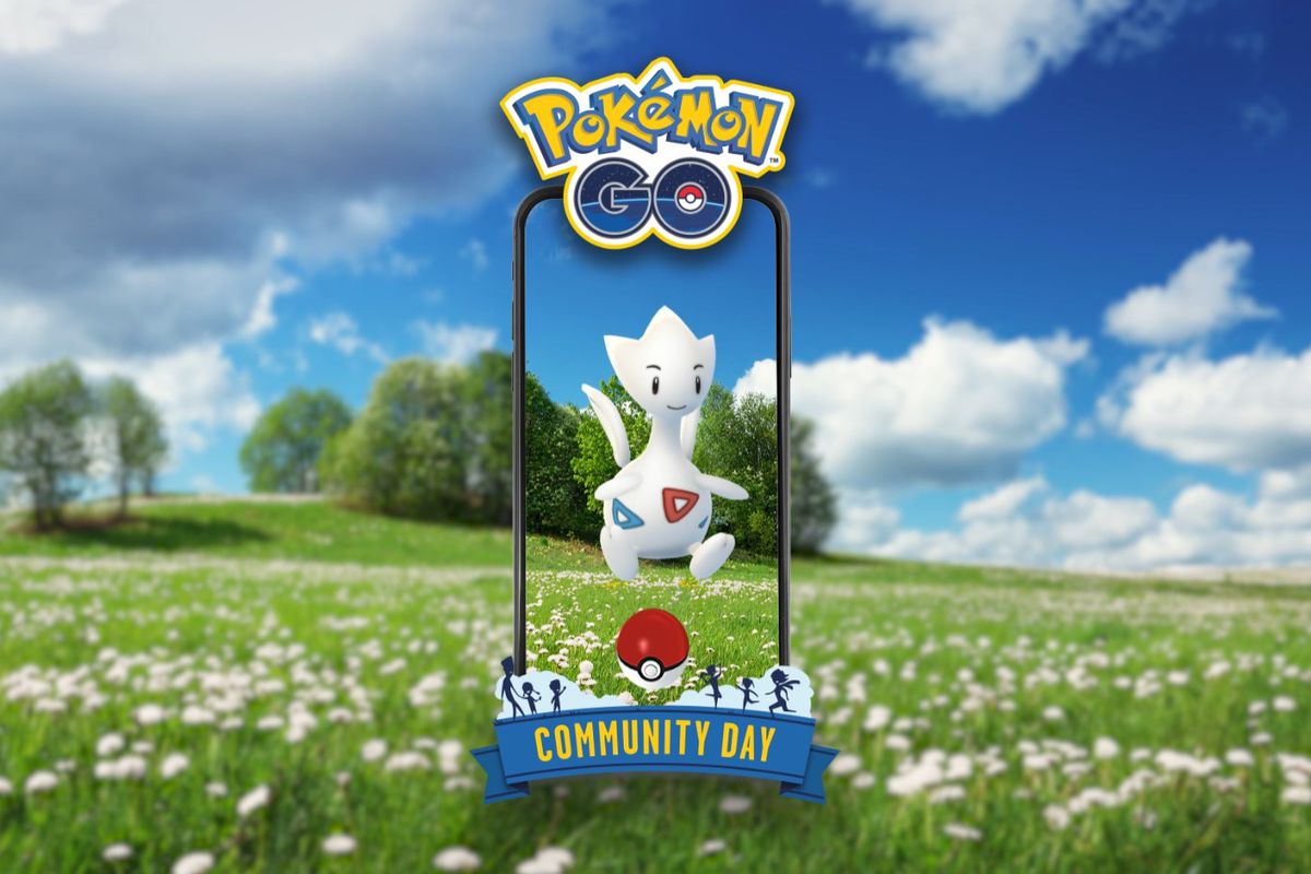 Togetic in Pokémon Go floating through the AR lens of a phone in a flowery field.