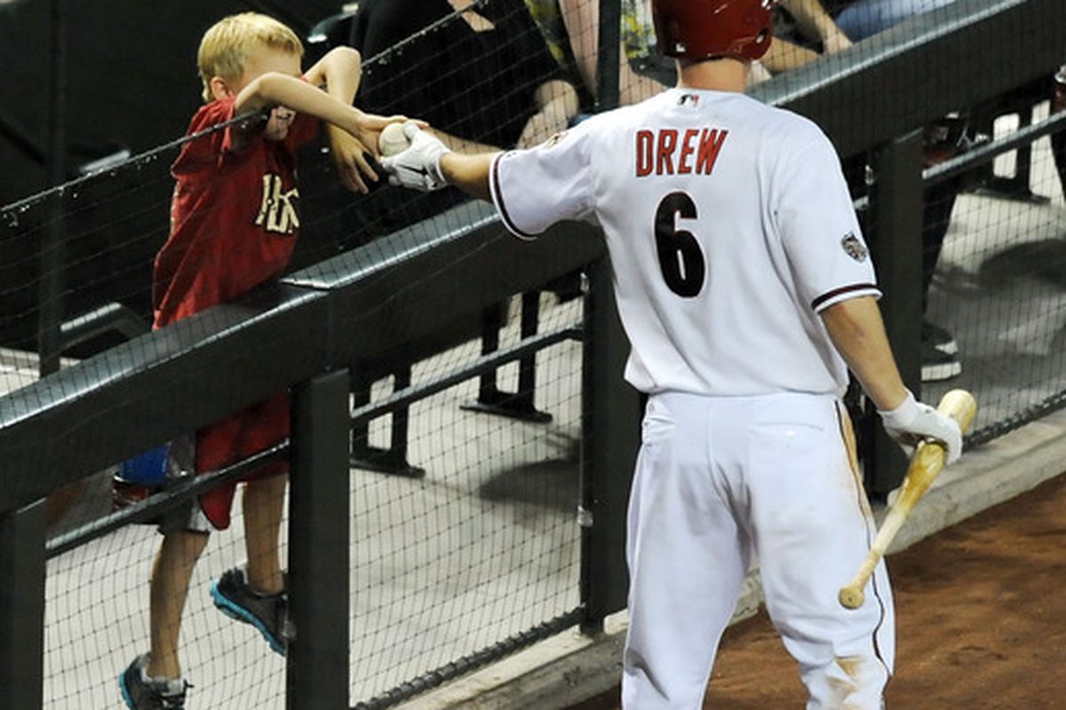 PHOENIX, AZ - JUNE 17:  Stephen Drew #6 of the Arizona Diamondbacks gives a foul ball to a young fan just prior to his at bat against the Chicago White Sox at Chase Field on June 17, 2011 in Phoenix, Arizona.  (Photo by Norm Hall/Getty Images)