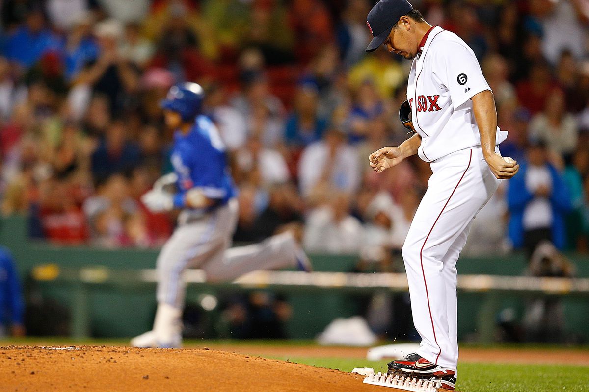 BOSTON, MA:  Daisuke Matsuzaka #18 of the Boston Red Sox reacts after giving up a home run to Yunel Escobar #5 of the Toronto Blue Jays in the fifth inning at Fenway Park in Boston, Massachusetts.  (Photo by Jim Rogash/Getty Images)