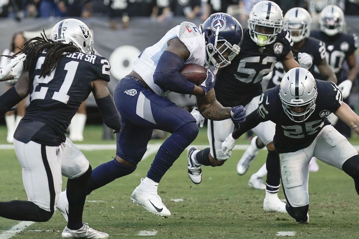 Tennessee Titans running back Derrick Henry runs against the Oakland Raiders during the third quarter at Oakland Coliseum.