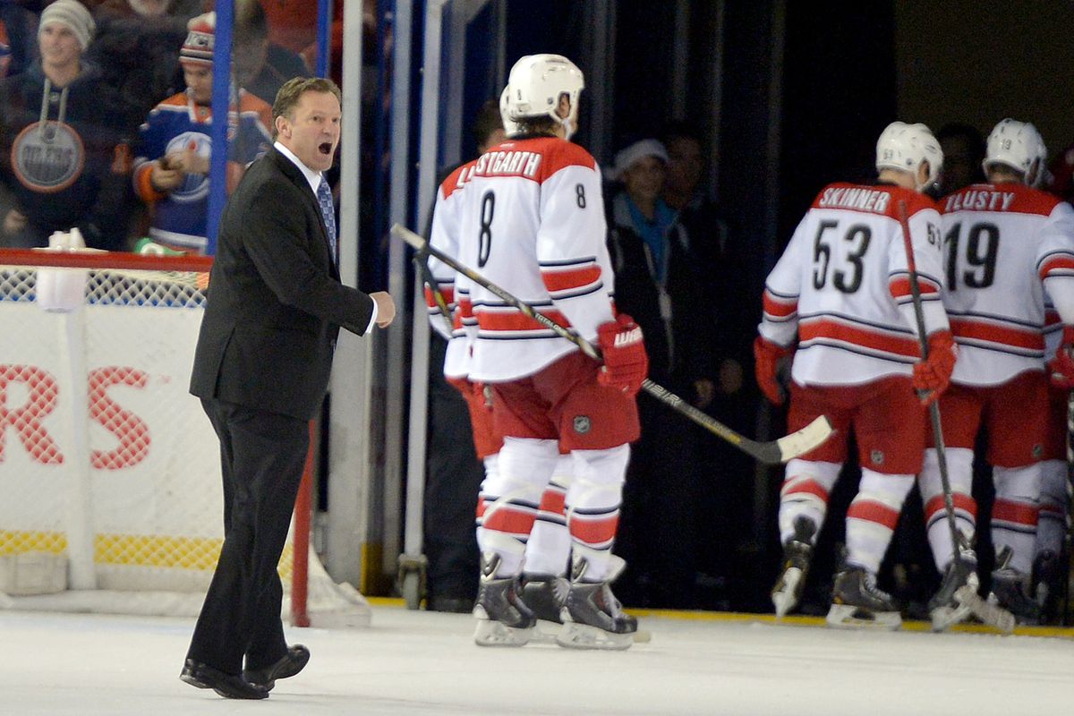 Carolina coach Kirk Muller expresses his displeasure with refs as he leaves the ice in Edmonton