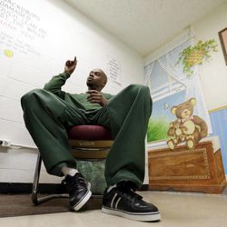 Attica Correctional Facility inmate Valentino Dixon talks about his golf art he creates in prison in Attica, N.Y., Thursday, May 16, 2013.   While serving a 39-year-to-life sentence for a murder he says he did not commit, Dixon draws, spending 10 to 12 hours a day illustrating a kind of serenity he has never known.