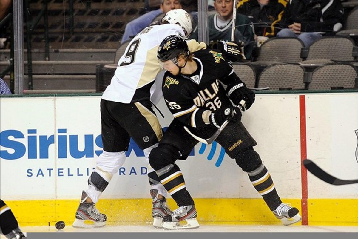 Feb 29, 2012; Dallas, TX, USA; Pittsburgh Penguins right wing Pascal Dupuis (9) and Dallas Stars defenseman Philip Larsen (36) fight for the puck during the first period at the American Airlines Center. Mandatory Credit: Jerome Miron-US PRESSWIRE