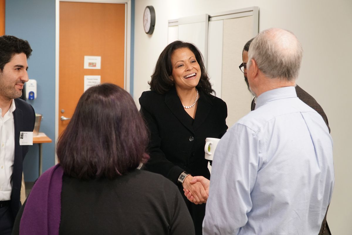 Silicon Valley Community Foundation CEO Nicole Taylor shakes hands with visitors.