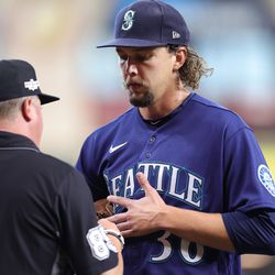 OCTOBER 11: Logan Gilbert #36 of the Seattle Mariners is checked by an umpire after the second inning in game one of the American League Division Series against the Houston Astros at Minute Maid Park on October 11, 2022 in Houston, Texas
