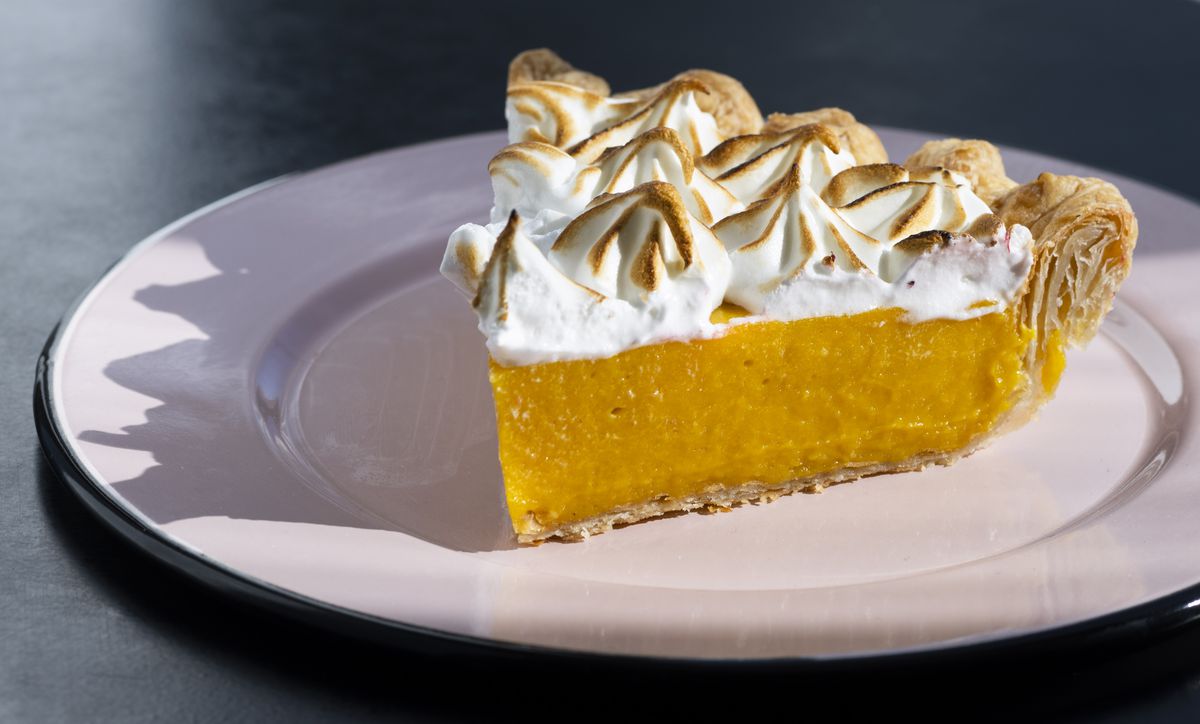 A slice of pie topped with toasted meringue.