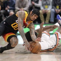 Utah Jazz guard Jordan Clarkson (00) and New Orleans Pelicans forward Herbert Jones (5) collide while diving for the ball during an NBA game at the Vivint Arena in Salt Lake City on Friday, Nov. 26, 2021. The Jazz lost 97-98.