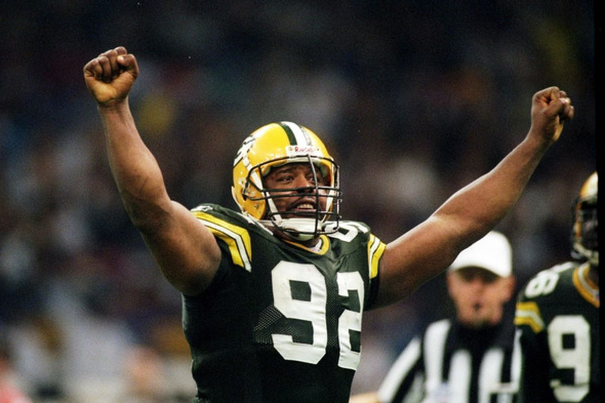 Reggie White raises his hands in victory over the NFL.