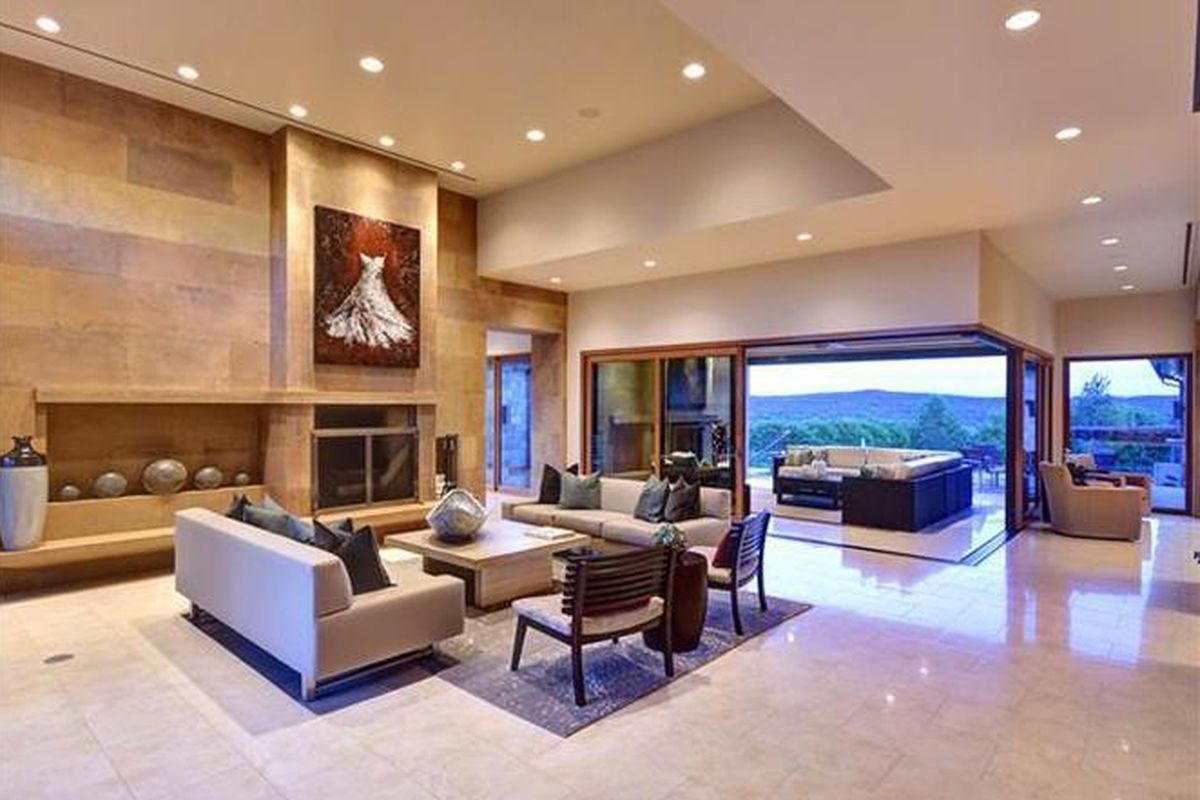 Large contemporary living area with wall-sized window door 