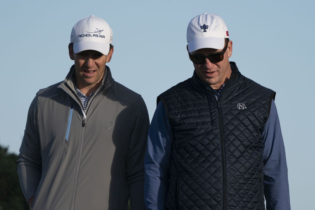Eli Manning (left) and Peyton Manning (right) walk on the 11th hole during the second round of the AT&amp;T Pebble Beach Pro-Am golf tournament at Monterey Peninsula Country Club - Shore Course.