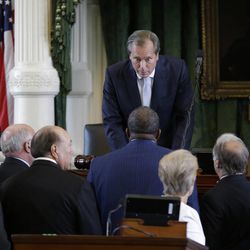 Lt. Gov. David Dewhurst, center, holds a conference with senators to discuss a rule during Sen. Wendy Davis', D-Fort Worth, filibusters in an effort to kill an abortion bill, Tuesday, June 25, 2013, in Austin, Texas. The bill would ban abortion after 20 weeks of pregnancy and force many clinics that perform the procedure to upgrade their facilities and be classified as ambulatory surgical centers.  (AP Photo/Eric Gay)
